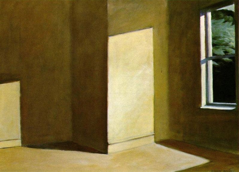 Interior de una habitación vacía con paredes beige y una ventana abierta por donde entra la luz del sol, creando sombras geométricas en el suelo y las paredes